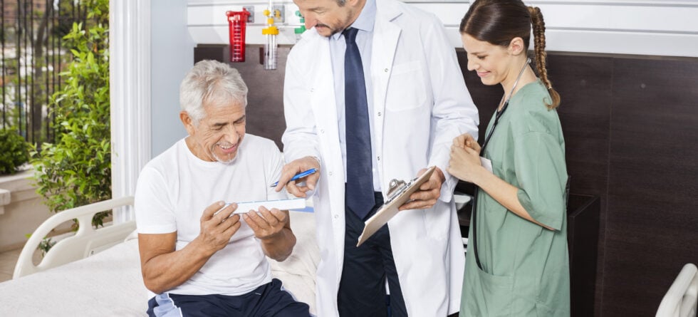 Senior doctor and caregiver talking about Medicare and assisted living in Wichita, ks