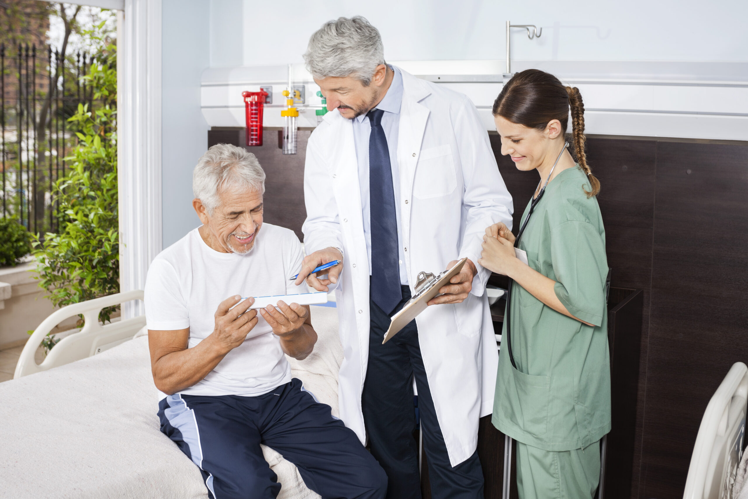 Senior doctor and caregiver talking about Medicare and assisted living in Wichita, ks