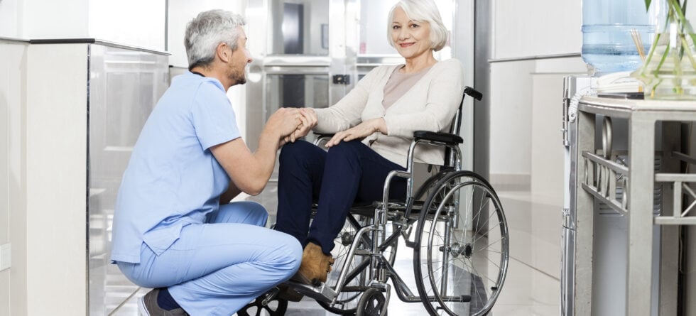 Senior woman with caregiver discussing assisted living versus long term care options in Wichita, Kansas