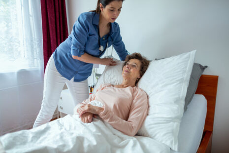 Care coordinator reviewing assisted living qualification forms with Wichita senior